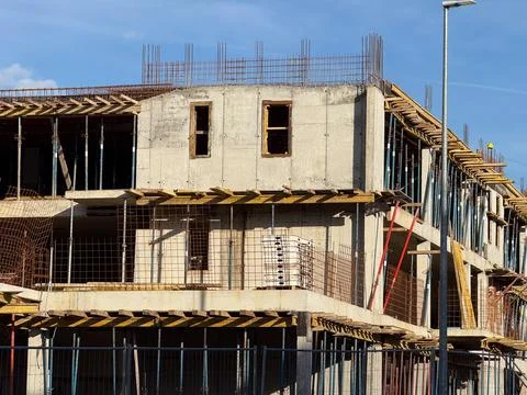 Close view of unfinished concrete building walls and metal reinforcement gr.. Stock Photos