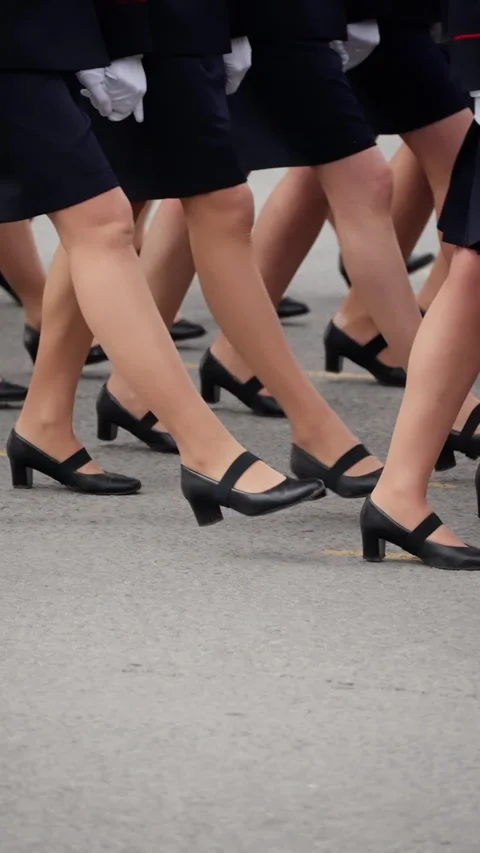 Close-up view of uniformed marchers stepping in synchronized formation on a Video stock 317560309