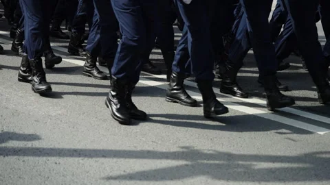 Close-up view of uniformed personnel marching in synchronized formation on a Stock Footage 336009337