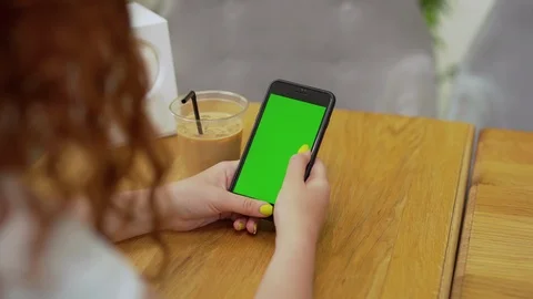 Close up view of unrecognizable curly red-haired woman using green screen phone Stock Footage 114247258