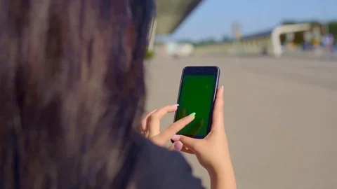 Close up view of unrecognizable female actively typing messages via green screen Stock Footage 114245135