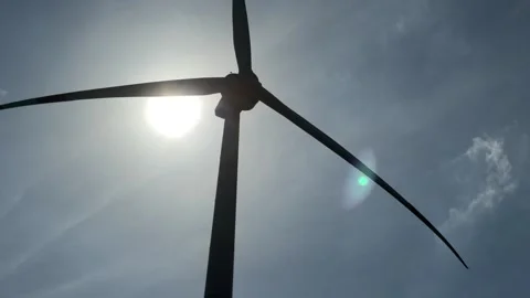 Close view of the upper section of a wind turbine as its blades rotate, set Stock Footage 327908183