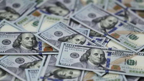 Close-up view of US dollar banknotes stacked in a disordered arrangement, Stock Footage 327698871