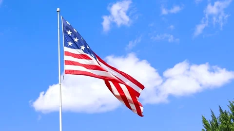 Close up view of USA flag waving against blue sky Stock Footage 293658478