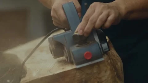 Close up view of using an electric hand planer Stock Footage 266866632
