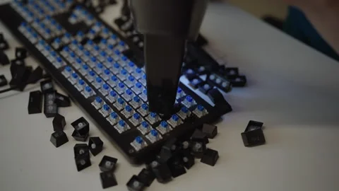 Close-up view of vacuum cleaner removing dust and debris from blue switches of Stock Footage 342764816