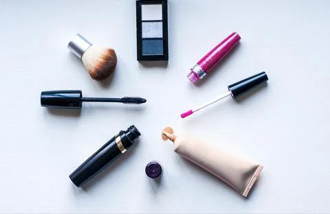 Close up view of various brushes and cosmetics for applying makeup on table Stock Photos
