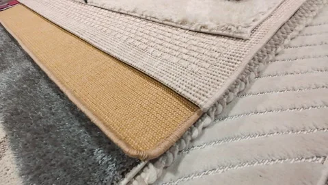 Close-up view of various carpet textures in a store setting.  Video stock 326147823