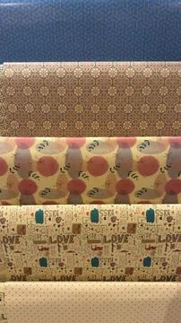 Close-up view of various decorative paper rolls with different patterns and.. Stock Photos