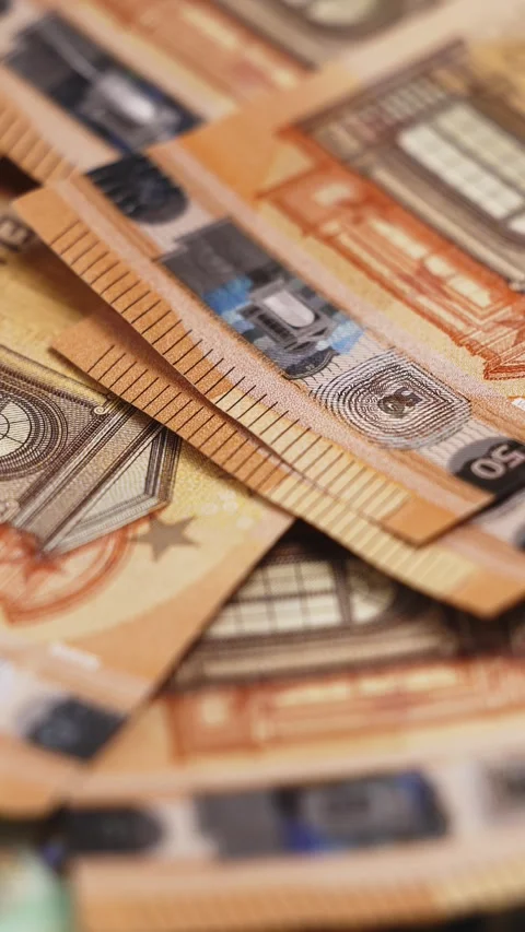 Close-up view of various euro banknotes stacked together, showcasing intricate Stock Footage 328124695