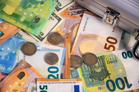 Close-up view of various Euro banknotes and coins, with a US dollar bill pe.. Stock Photos