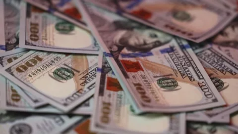 Close-up view of various hundred-dollar bills stacked together, showcasing Stock Footage 327698877