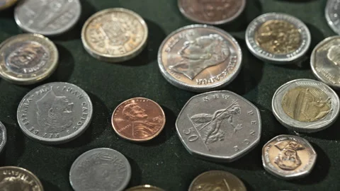 Close Up View of Various International Metal Coins with Detailed Portraits Stock Footage 339713741
