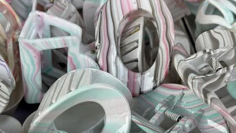 Close up view of various marbled plastic hair claw clips showcasing a fashion 库存照片