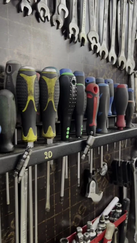 A close-up view of various mechanic tools organized on a wall. Includes Stock Footage 318829786