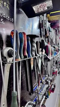 A close-up view of various mechanic tools organized on a wall in an auto Stock Photos