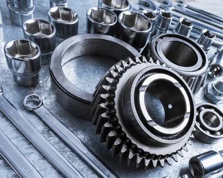 Close-up view of various metal tools and mechanical parts arranged on workbench Stock Photos