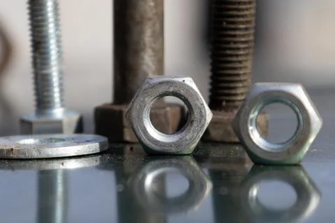 Close up View of Various Nuts and Bolts on a Reflective Surface in a Worksh.. Stock Photos