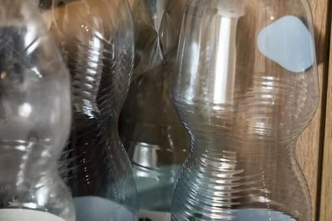 A close-up view of various plastic bottles arranged against a wooden background, 스톡 사진