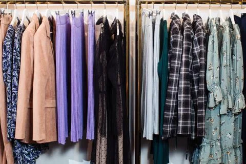 Close-up view of various stylish clothes hanging on hangers in boutique. Clothes 写真素材