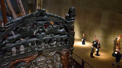 Close view of Vasa ship front from upper floor with visitors walking past Stock Footage 338187074