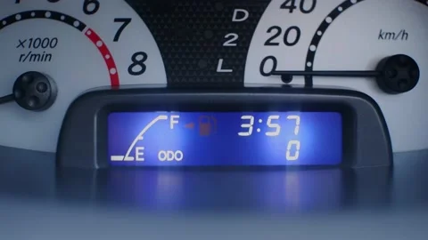 Close-up view of a vehicle dashboard with a blinking empty fuel tank indicator. Stock Footage 162343148