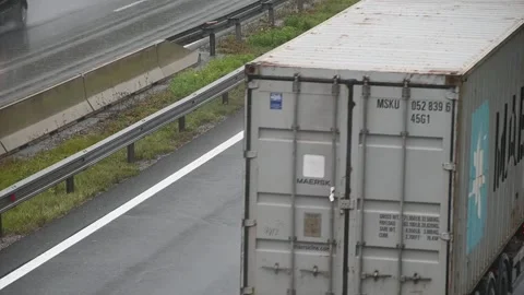 Close up view of vehicles passing by on wet highway road Stock Footage 164686659