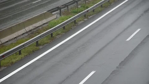Close up view of vehicles passing by on wet highway road Stock Footage 164686692
