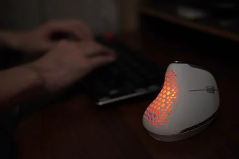 A close-up view of a vertical computer mouse against the background of a pr.. Fotos de archivo