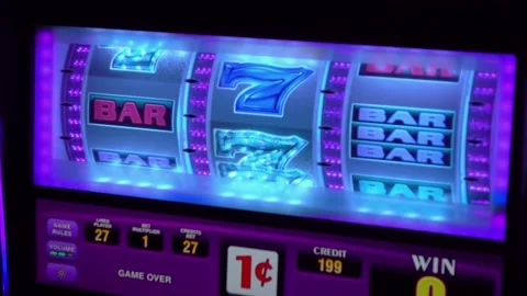 Close-up view of a vibrant slot machine screen displaying various symbols a.. Stock-Footage 281077854