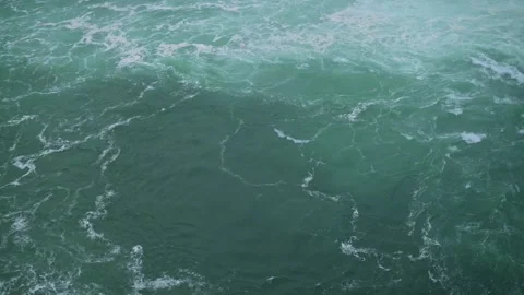 Close-up view of vibrant water surface featuring ripples swirling currents Stockbeeldmateriaal 292604057