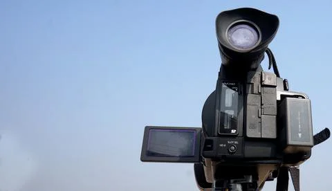 Close-up view of Video Camera against blue sky in outdoors Stock Photos