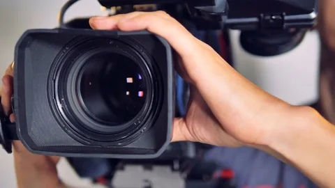 Close-up view on a video camera moved by male hands. Stock-Footage 82168153