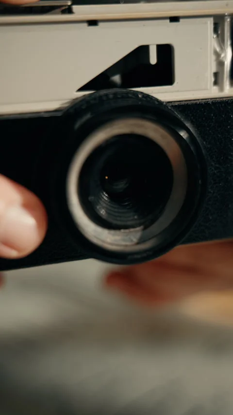 Close view of vintage camera lens and hand Stock Footage 336568755