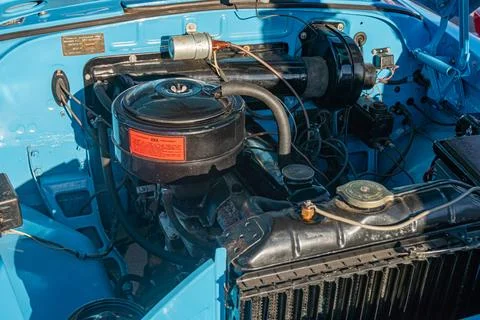 Close-up view of a vintage car engine in various shades of blue Central focus Stock Photos