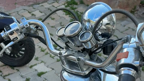 Close-up view of vintage motorcycle handlebars featuring chrome detailing o.. Video stock 325859070