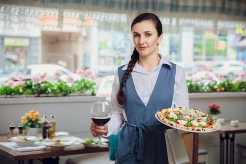 Close up view of waiter serving dishes at restaurant Foto stock