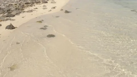 Close up view walking along the white golden sandy beach with light crystal clea Stock Footage 245442195