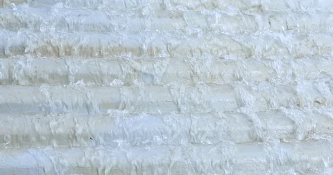 Close-up view on the wall with falling water 動画素材 121358152