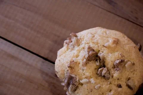 Close up view of walnuts and muffin on wooden planks. Stock Photos