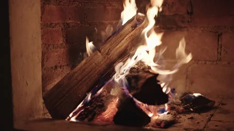 Close up view of a warm fire with burning logs inside a rustic brick fireplace 動画素材 342042014