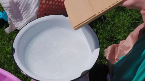 Close up view of Washing clothes on old vintage washboard outdoors. Young Woman Stock Footage 274510702