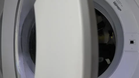 Close up view of a Washing Machine in Action Spinning Laundry Load Stock Footage 294071377