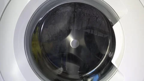 Close up view of a Washing Machine in Action Spinning Laundry Load Stock Footage 294072590