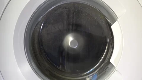 Close up view of a Washing Machine in Action Spinning Laundry Load Stock Footage 294073108