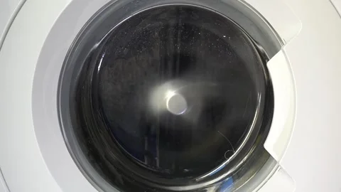 Close up view of a Washing Machine in Action Spinning Laundry Load Stock Footage 294104025