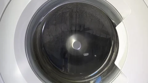 Close up view of a Washing Machine in Action Spinning Laundry Load Stock Footage 294104238