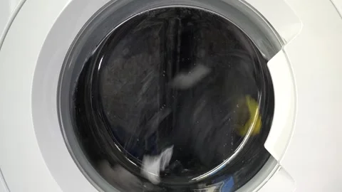 Close up view of a Washing Machine in Action Spinning Laundry Load Stock Footage 294105041