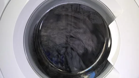 Close up view of a Washing Machine in Action Spinning Laundry Load Stock Footage 294105254