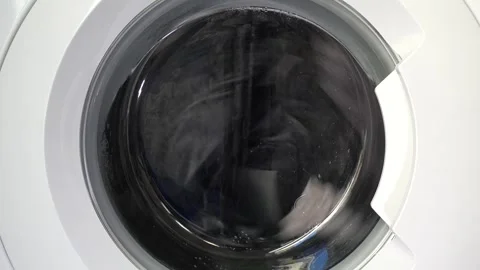 Close up view of a Washing Machine in Action Spinning Laundry Load Stock Footage 294105316